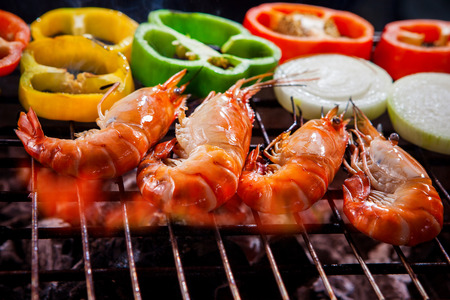 shrimp,prawns grilled on barbecue fire stove with chilly onion for seafood mealの写真素材