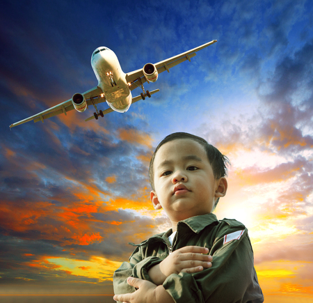 asian children dreaming to be plane pilotの写真素材
