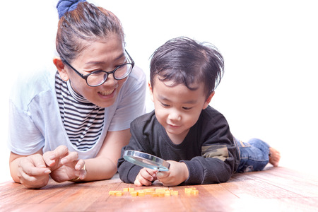 asian family mother and children playing on wood floorの写真素材