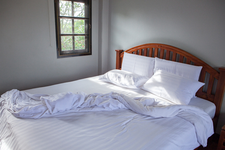 empty white pillow clothes  and messy blanket bed roomの写真素材