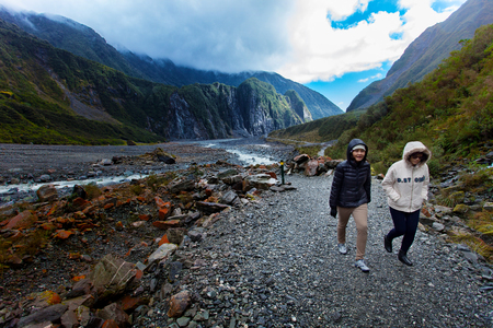 FRANZ JOSEF GLACIER NEW ZEALAND - SEP4,2015 : unidentified tourist trekking in franz josef glacier natural trail ,franz josef is most popular traveling destination in west coast of south island of new zealandのeditorial素材