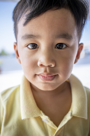 close up face asian children looking eyes contact to cameraの写真素材