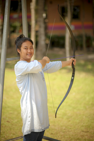 asian teenager practice to playing archery in play ground