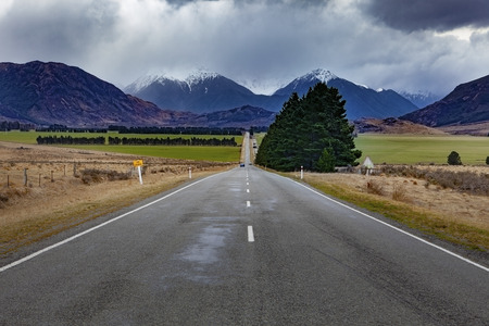 beautiful scenic straight way of route 73 from east to west coast of south island new zealand の写真素材