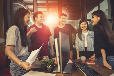 younger asian freelance laughing with happiness face in home officeの写真素材