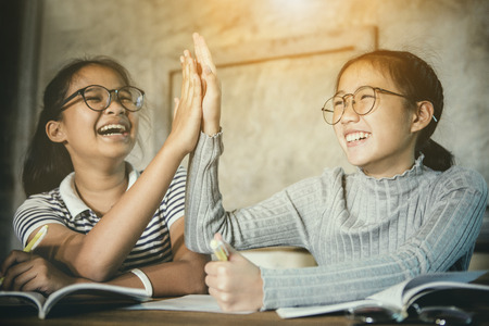 two asian teenager happiness emotion celebrating education successfulの写真素材