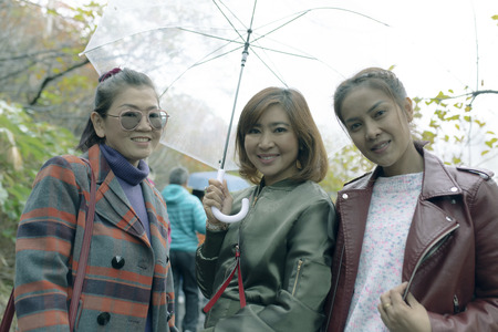 three asian woman friend holding raining umbrella happiness emotion traveling in hokkaido japan