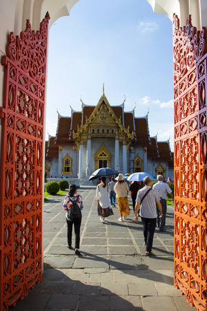 bangkok thailand - october27,2018 : group of tourist walking through wat benchamabophit entry door ,wat ben or marble temple is one of most popular traveling destination in heart of thailand capitalのeditorial素材