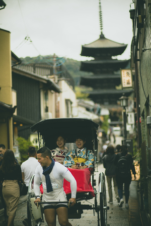 kyoto japan - november9,2018 : japanese woman wearing kimono old traditon clothes sitting in rickshaw on yasaka street,yasaka shrine one of most popular traveling destination in kyotoのeditorial素材
