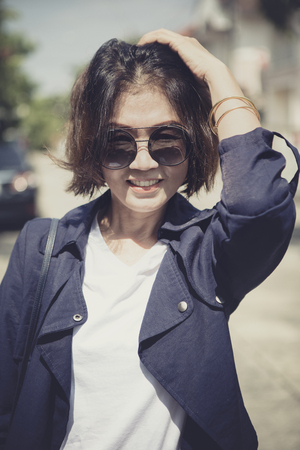 toothy smiling face of beautiful asian woman relaxing with happiness emotionの写真素材