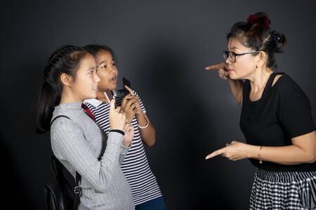 woman teacher and  two girl student excited,
violence themeの写真素材