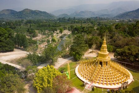 aerial view of gold buddist pagoda in saraburi central of thailand