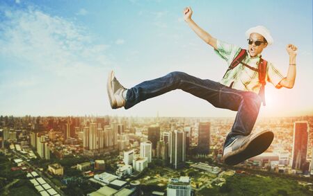 traveller man jumping floating over modern city skyscraperの写真素材