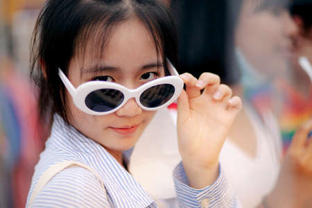 close-up face of asian teenager wearing fashion eye glassesの写真素材