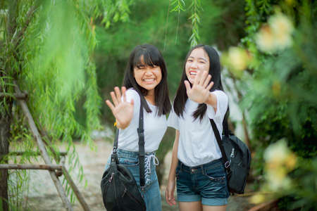 two asian teenager happiness in parkの写真素材