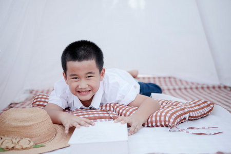 smiling face of asian children lying on floor