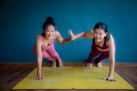 two asian woman doing yoga with happiness