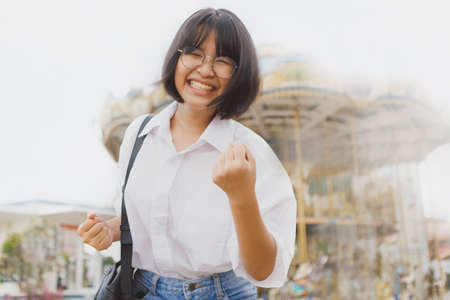happiness face of asian teenager standing outdoorの写真素材