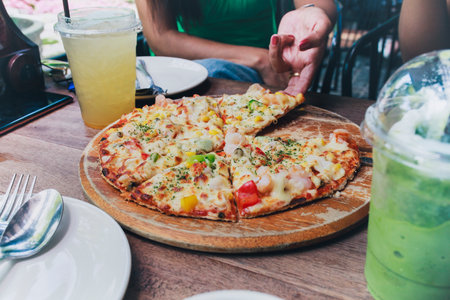 italian pizza hawaiian dressing style ready to eating on wood plateの写真素材