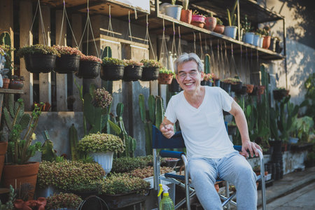 asian senior man smiling with happiness face at home gardenの写真素材