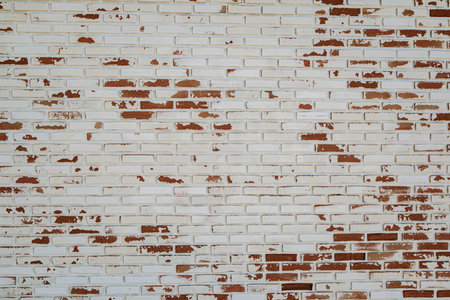 old white paint on red brick wall use as grounge backgroundの写真素材
