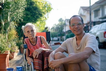 asian son and old mother happiness with relaxing time at home villageの写真素材
