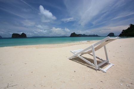white chair on the beachの写真素材