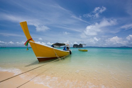yellow boat in indigo seaの写真素材