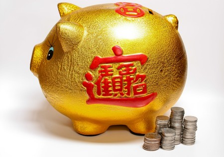 gold piggy bank for savingsの写真素材