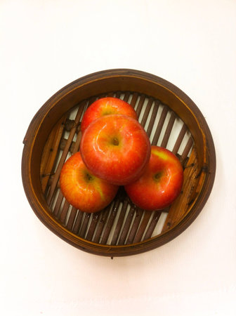 Fresh apples in the basket on white background.の素材