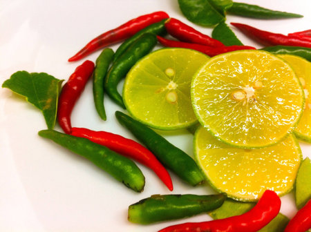 Fresh paprika and lemon on the white .