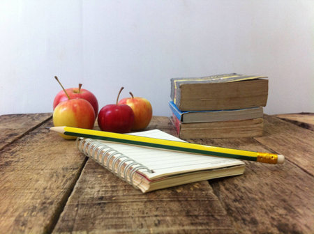 Apple and book on the woodenの素材