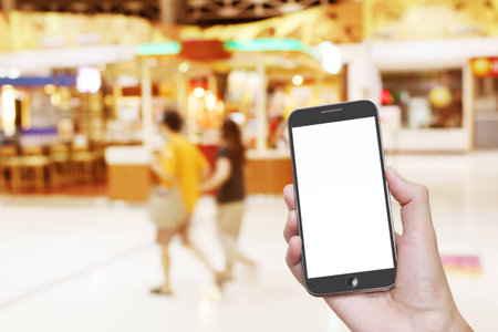 Man Hand holding White Smartphone with blank screenの写真素材