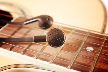 Black earphone on the guitar,vintage retroの写真素材