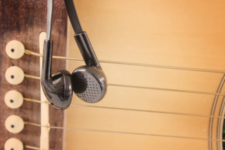 Black earphone on the guitar,vintage retroの写真素材