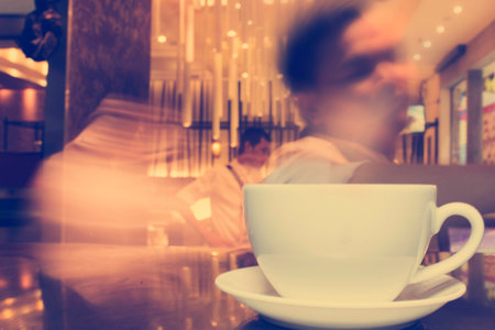 Cup of coffee in coffee shop,vintage effect blur styleの写真素材