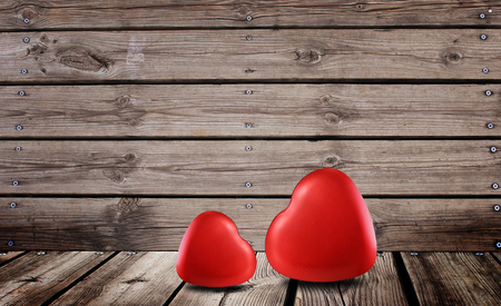 Red hearts symbol of love on the wooden background for valentine dayの写真素材