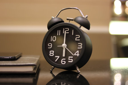 Alarm clock on a desk in the office. Time concept.の写真素材