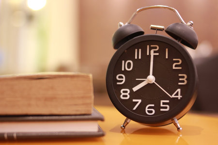 Alarm clock and books on the table. Time to study.の写真素材