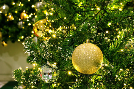 Christmas tree decorated with golden balls and garland. Christmas background.の写真素材
