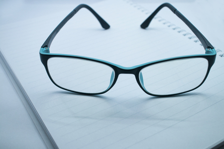 Blue glasses and notebooks.の写真素材