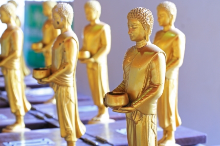 Rows of standing Buddhas holding monk s alms-bowls at the temple of Wat Phra Mahathat, Nakhon Si Thammarat, Thailand の写真素材
