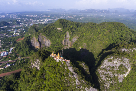 Aerial view of Tiger Cave Temple or Wat Thum Sua at Krabi province, Thailand. At the top of the mountain there is a large golden Buddha statue which is a popular tourist attraction.の写真素材