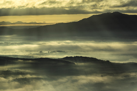 A beautiful shot of early morning fog over mountains landscape in Hat Yai, Thailandの写真素材