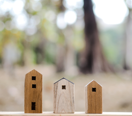 Three Wood toy house with blur forest and lake backgroundの写真素材