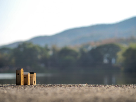 Three Wood toy house with blur forest and lake backgroundの写真素材