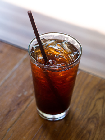 Americano with ice on table wood with blur backgroundの写真素材