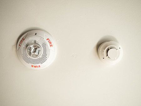 Fire warning on white wall in a buildingの写真素材