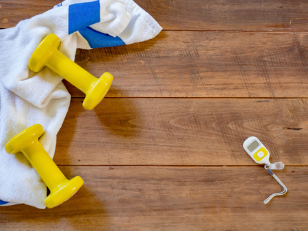 Exercise equipment on wood background for good healthy, free spaceの写真素材