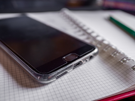 One Smartphone and notebook and calculator on table for meeting and workの写真素材